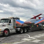 Government contract trucking of semi truck hauling government airplane